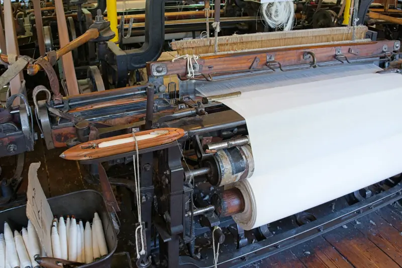 Weaving loom producing white greige fabric