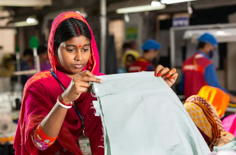 Quality inspector checking fabric on the factory floor
