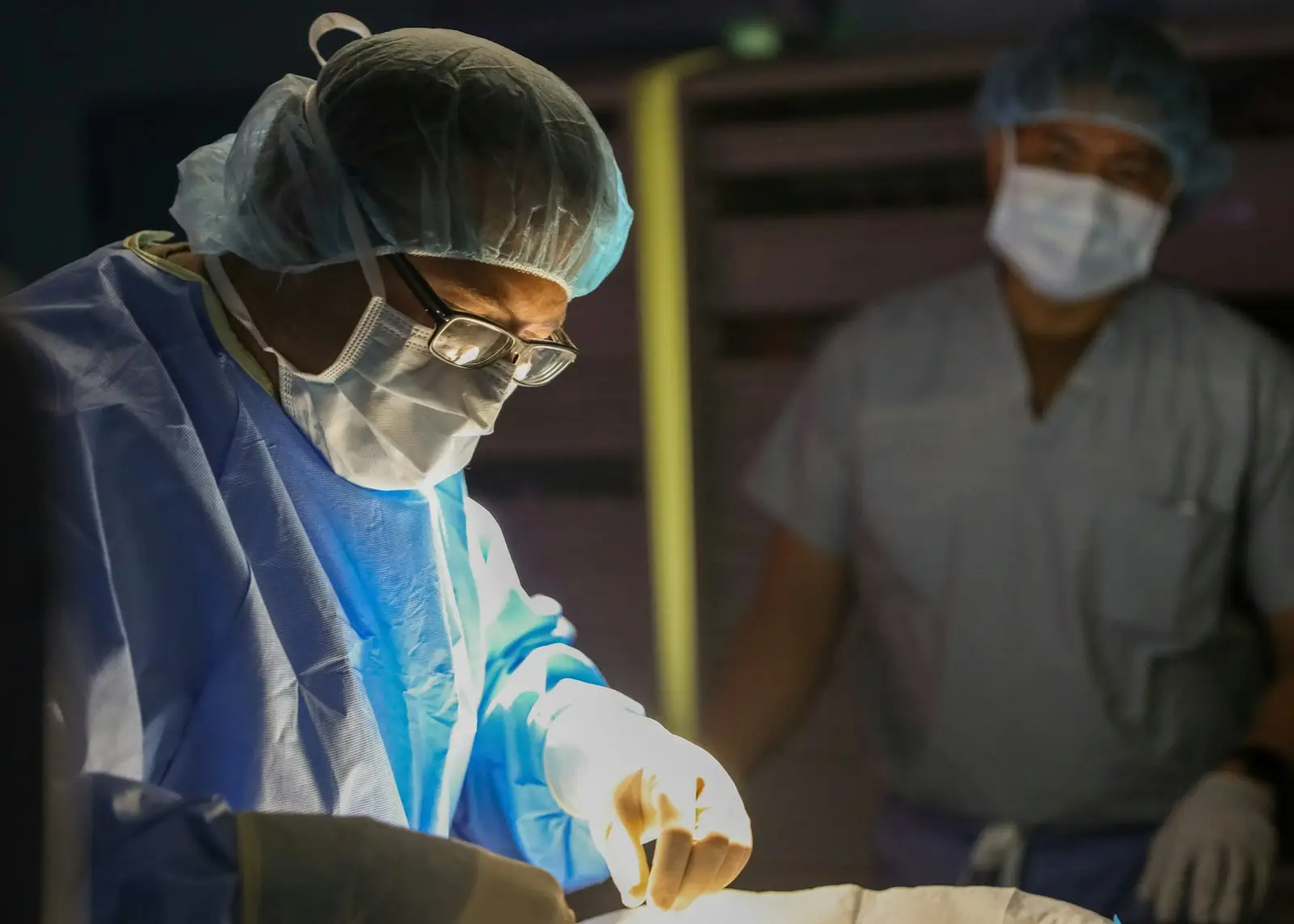 Surgeons in sterile gowns and masks during surgery