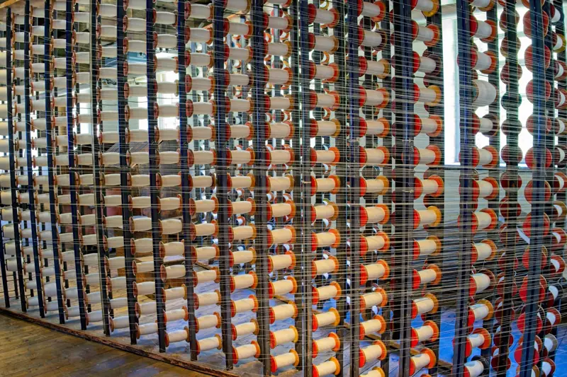 Rows of yarn cones on a textile machine