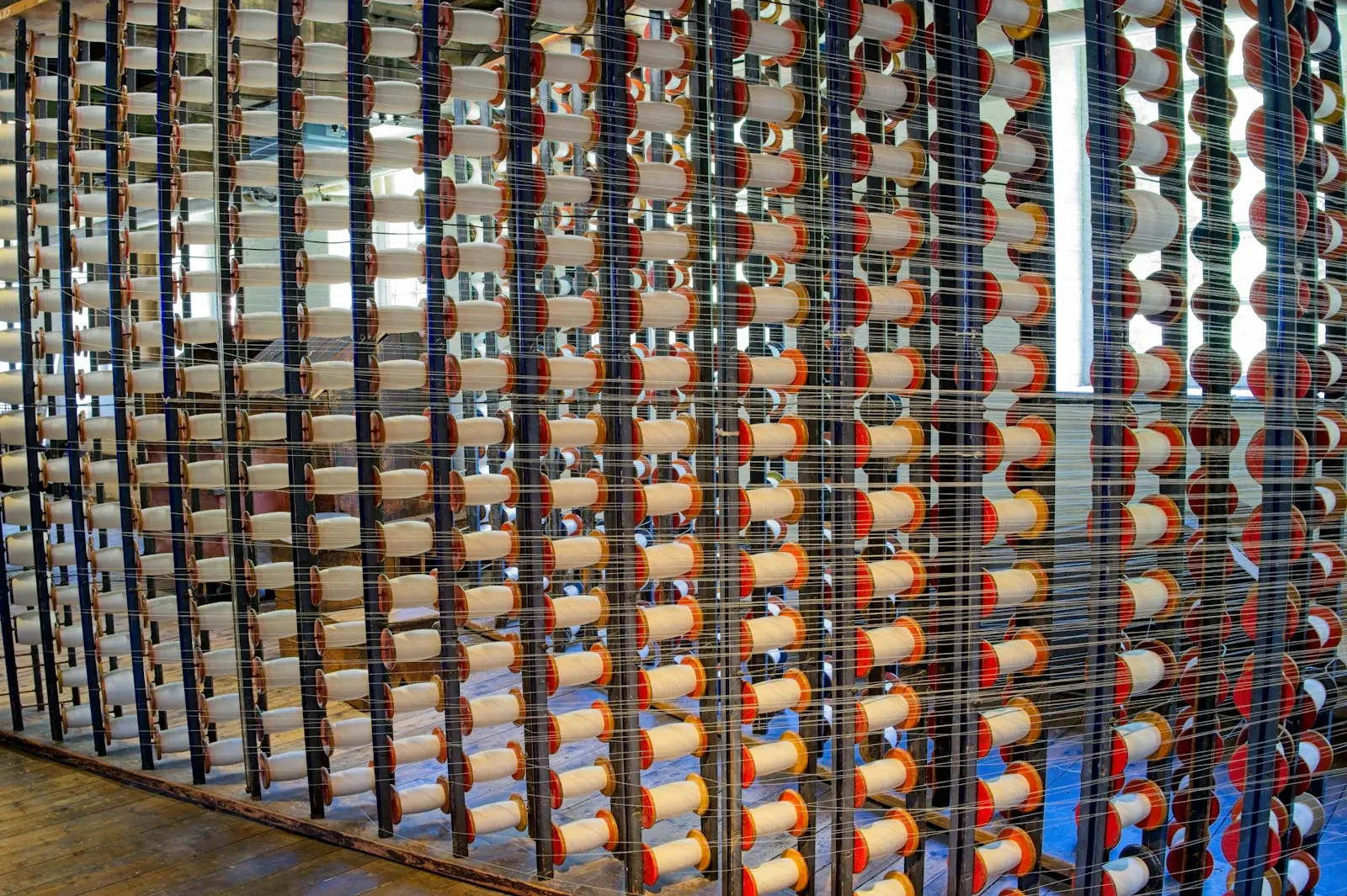 Rows of yarn cones on a textile machine